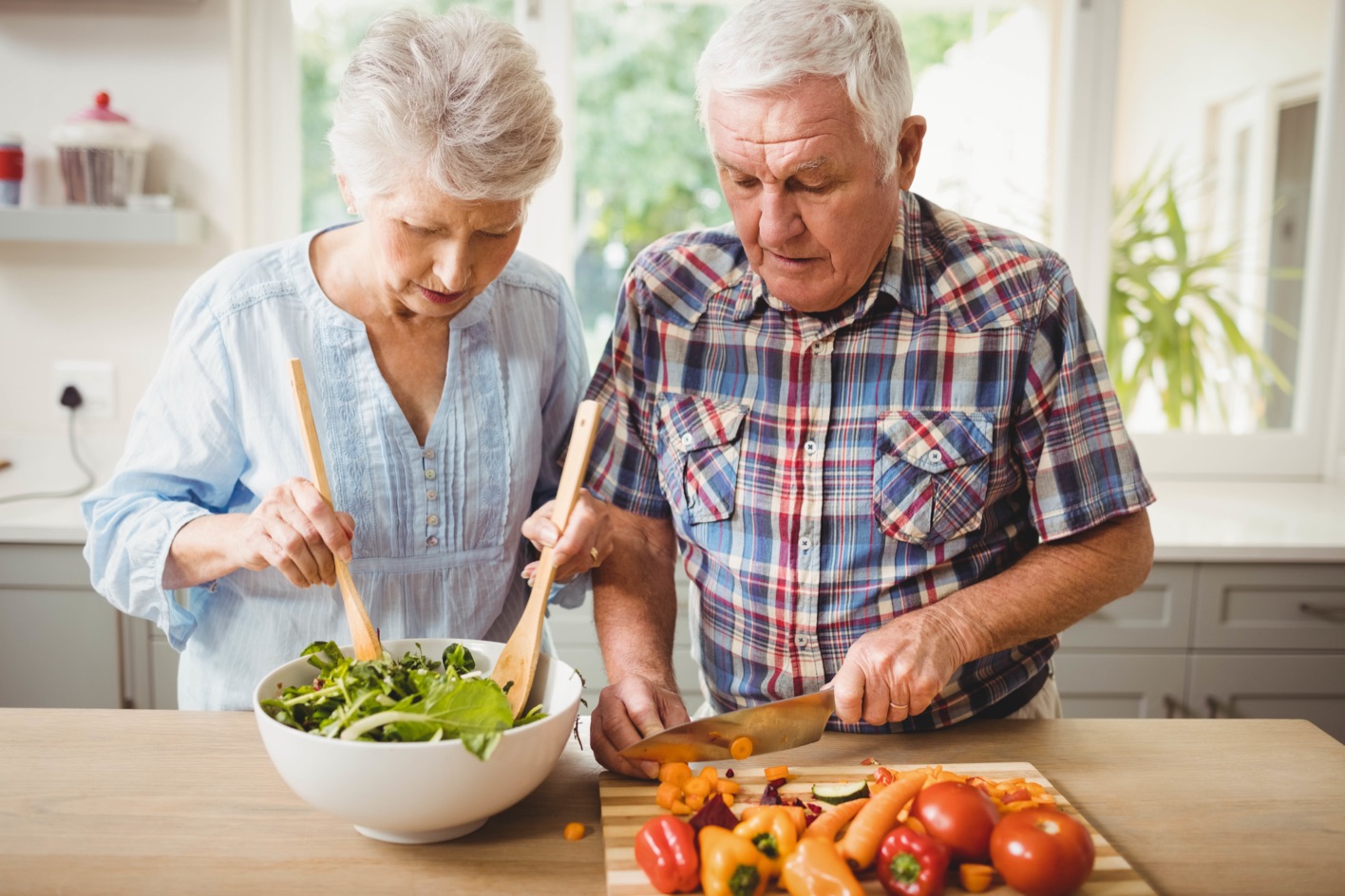 A couple preparing a fresh meal together in a kitchen