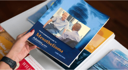 Woman holding Asbestos.com 2025 mesothelioma guide