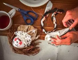 Woman making a cloth doll Woman making a cloth doll