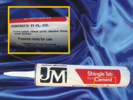 A tube of asbestos cement made by Johns Manville on a blue background