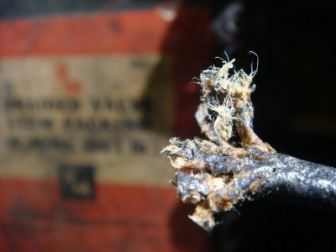 The frayed end of a valve packed with asbestos fibers