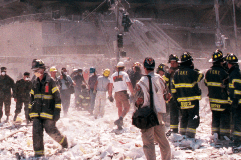 First responders standing among debris at 