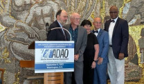 ADAO conference group photo at podium