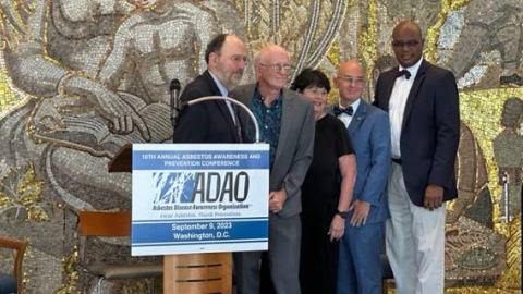 ADAO conference group photo at podium