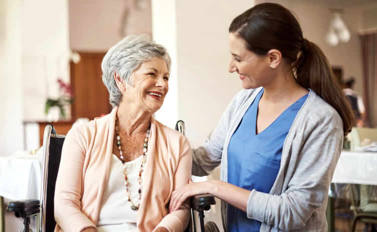 Shot of a young nurse caring for a senior woman in a retirement home