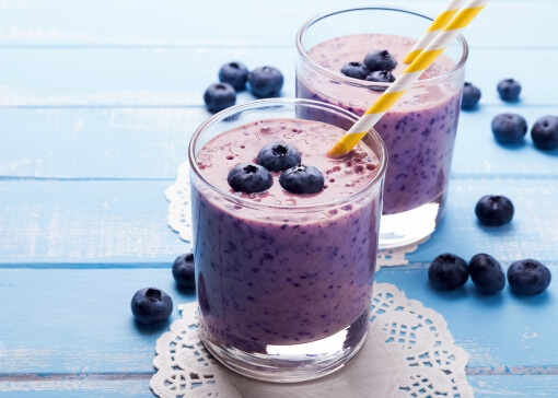 Blueberry smoothies in glasses with berries