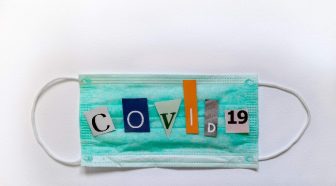 Medical mask with COVID 19 in cutout letters