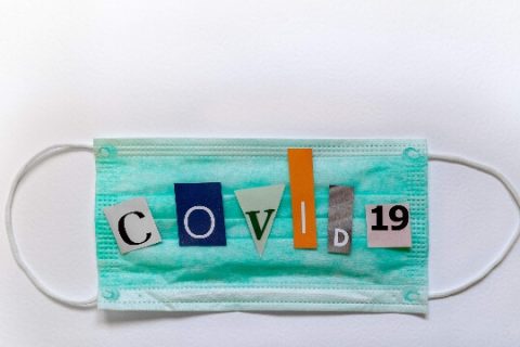 Medical mask with COVID 19 in cutout letters