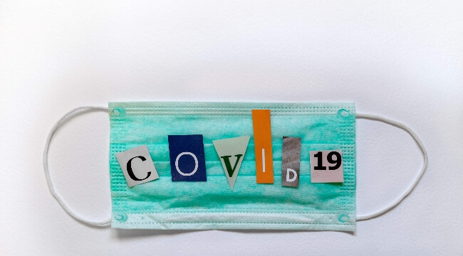 Medical mask with COVID 19 in cutout letters