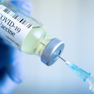 COVID-19 vaccine vial with syringe