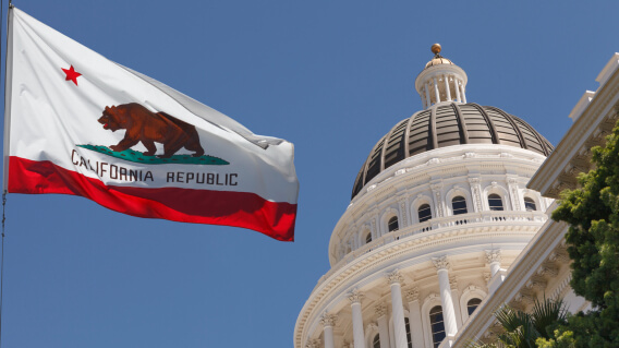 California state capitol with flag