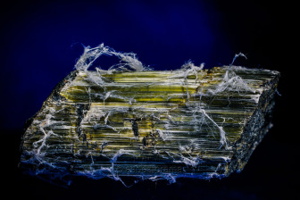 example of chrysotile asbestos ore, showing natural fibrous habit and greenish coloration.