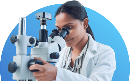 Young scientist reviewing sample under a microscope