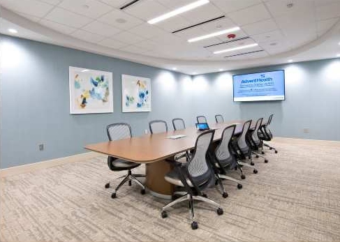 Conference room with table, chairs and monitor