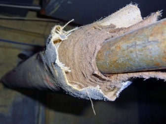 Damaged asbestos insulation on pipe