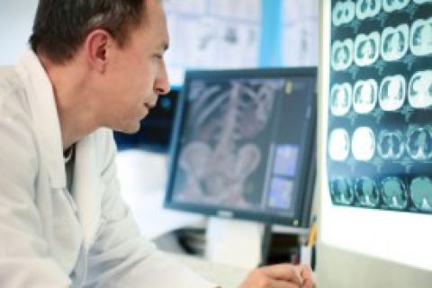 Male doctor looking at X-ray scans