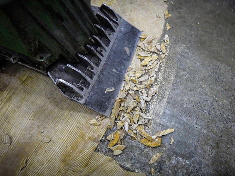 Floor scraper with bits of asbestos backing