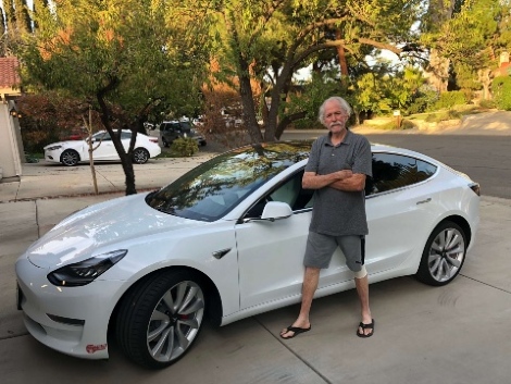 Jim Huff with his white Model S Tesla