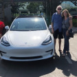 Jim and Kathy Huff with their white Tesla