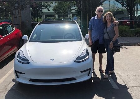 Jim and Kathy Huff with their white Tesla