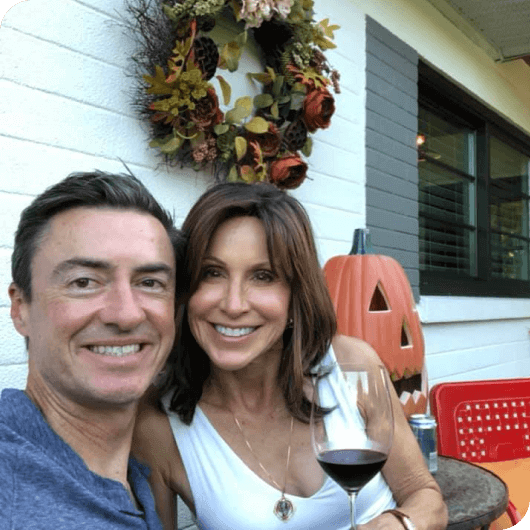 Karen Selby sitting on front porch with her husband
