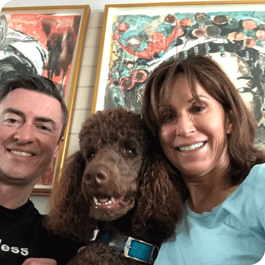 Karen Selby smiling with husband and her dog