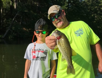 Kevin Sinyard and his grandson show off a fish