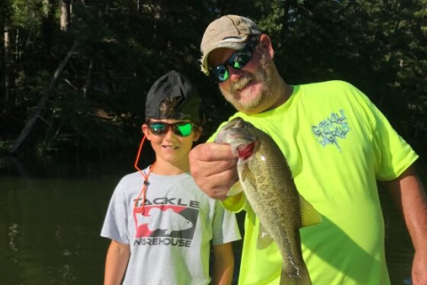 Kevin Sinyard and his grandson show off a fish