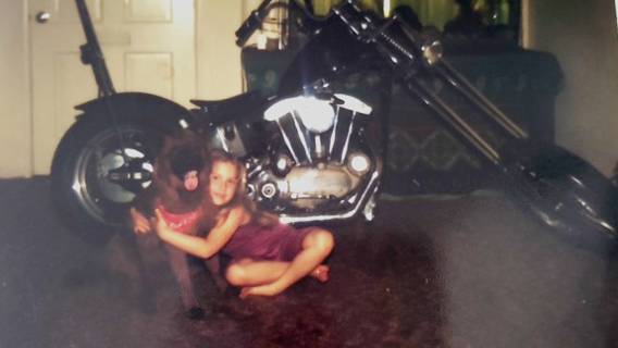 Lisa Oaks with her dog and her dad's motorcycle