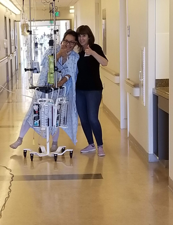 Kim Madril and Jeanette Mednicoff walk the hospital corridor