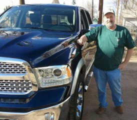 Mesothelioma Survivor Nick P. next to his blue truck