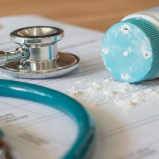 Teal stethoscope and talc bottle in teal