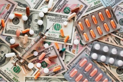 Prescription drugs scattered over American currency
