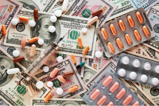 Prescription drugs scattered over American currency