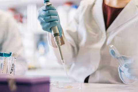 Close up of scientist hands, taking samples with pipette