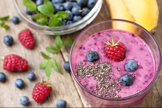 Strawberry blueberry smoothie in a glass with chia seeds