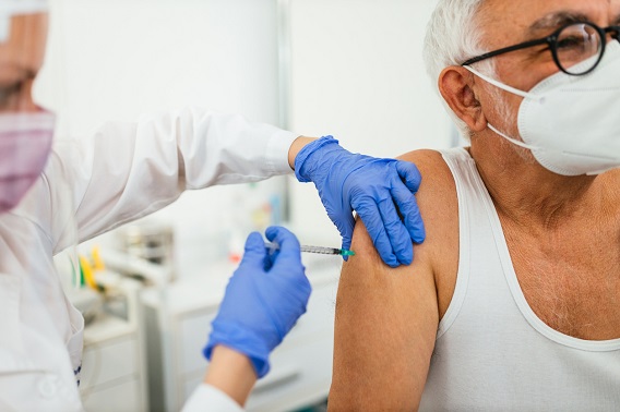 Doctor giving vaccine to patient in doctor's office