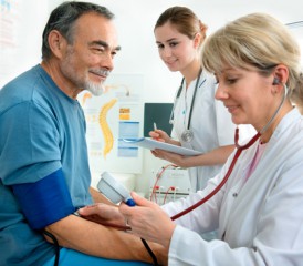 Female doctor treating an older man