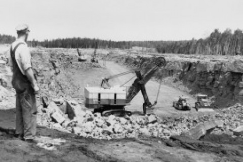 Worker overlooking pit