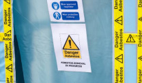 Danger Asbestos tape and sign on blue sheet