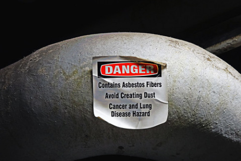 Danger sign, warning of asbestos fibers