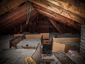 Loose insulation in a dark attic of an older home