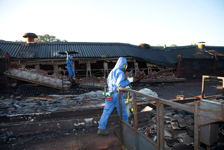 Workers removing asbestos from a demolition job