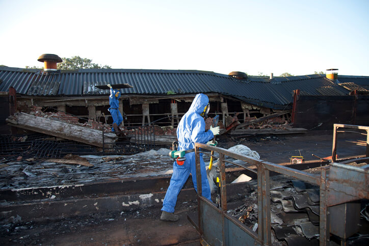 Workers removing asbestos from a demolition site