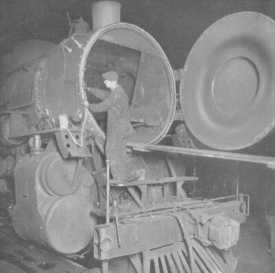 Railroad worker placing asbestos tape on train