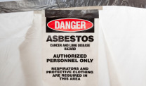 Danger asbestos sign on white tarp