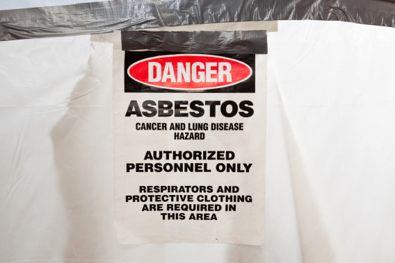 Danger asbestos sign on white tarp