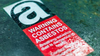 Red and white asbestos warning sticker
