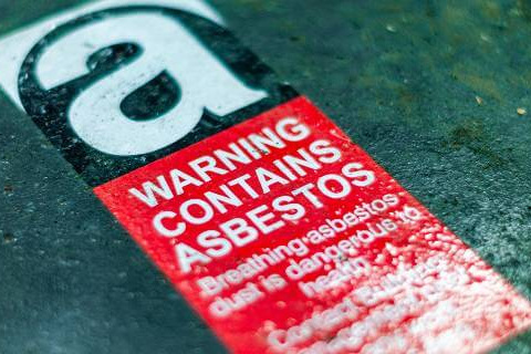 Red and white asbestos warning sticker