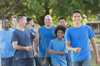 Group of people walking in blue shirts